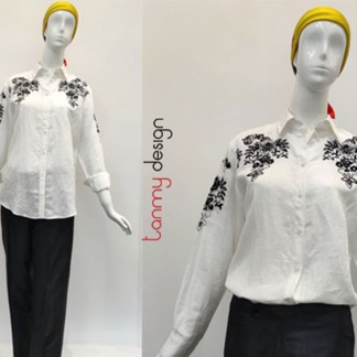 White top with black flowers embroidered on shoulders